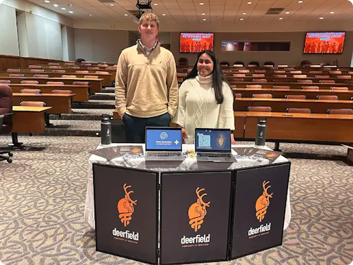 Two employees standing at a presentation booth