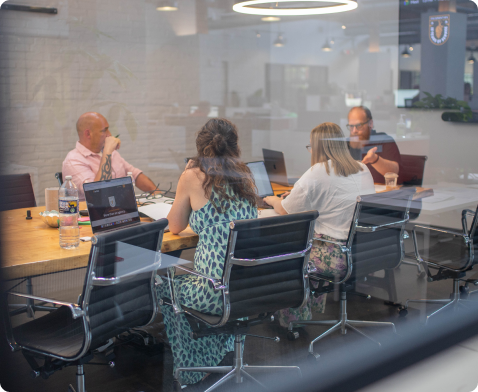 A group of employees discussing a project in a conference room